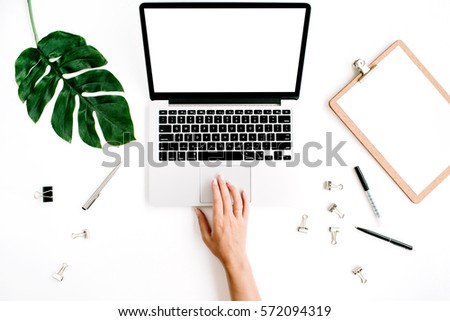 Woman working on laptop with blank screen. Flat lay, top view workspace