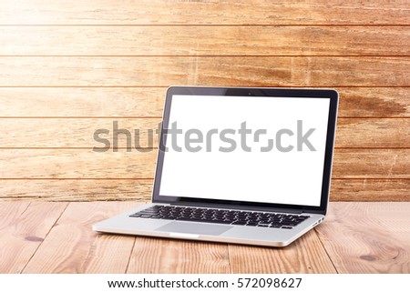 Front view of the laptop is on the work table wooden background 