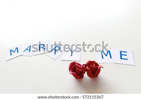"marry me" phrase with red flower on white background, happy valentine day, word background, alphabet art