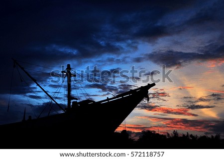 Silhouette of ship with sunset