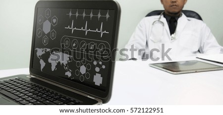 medicine doctor working with computer notebook and digital tablet  at desk in the hospital