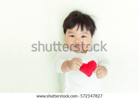 Red heart with adorable asian baby girl for valentine concept background and copy space.