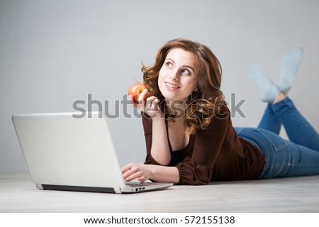 Young beautiful woman with a laptop and a apple