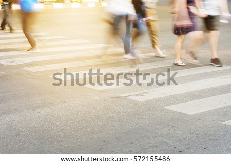 People are moving across the crosswalk on the city road, Close-up crosswalk
