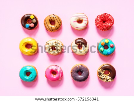colorful donuts on pink baclground.
