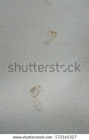 Human footprints on the sand, blurry photo andr focus a certain spot.