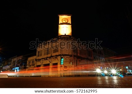 Traffic on the road The light source is the car's lines. at Surin Circle Clock Tower , phuket town, Thailand. Taken with slow shutter speed 