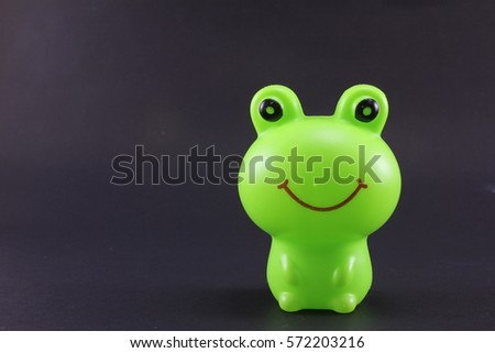 Plastic frog on black background
