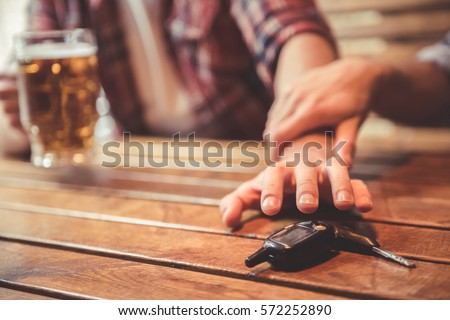 Do not drink and drive! Cropped image of drunk man talking car keys and his friend stopping him Royalty-Free Stock Photo #572252890