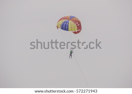 Tourists parasailing on Pattaya Beach