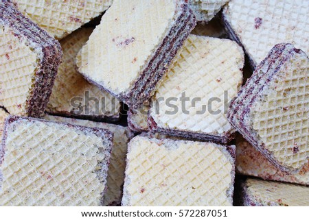 Creamy wafer biscuit texture. Neapolitan wafers are a wafer and chocolate cream sandwich biscuit. Sweets square wafer pattern studio food photography .