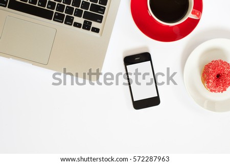white office desk table with computer notebook , cup of coffee and pink donuts. Top view with copy space, flat lay.
