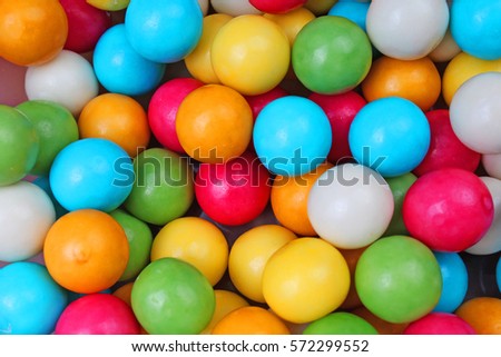  
Bubble gum chewing gum balls texture. Rainbow multicolored gumballs chewing gums as background. Round sugar coated candy dragee bubblegum texture. Food photography. Colorful bubblegums wallpaper. 