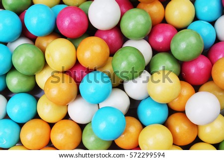  
Bubble gum chewing gum balls texture. Rainbow multicolored gumballs chewing gums as background. Round sugar coated candy dragee bubblegum texture. Food photography. Colorful bubblegums wallpaper. 
