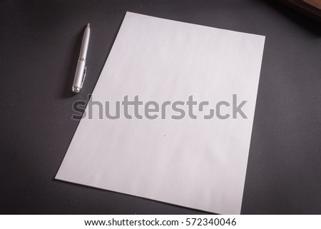 White paper and pen on leather background