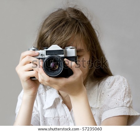 Girl holding an old film camera