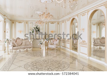 Luxurious vintage interior with fireplace in the aristocratic style Royalty-Free Stock Photo #572384041