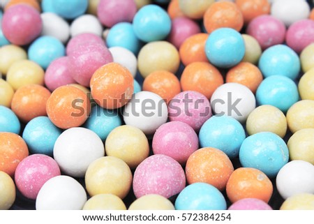 Shiny sugar coated round chocolate balls as background. Candy bonbons multicolored texture. Round candies sweets pattern concept. Food photo studio photography. Candy background