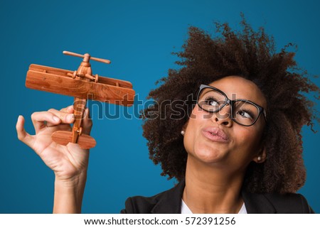 business black woman playing with a wooden plane