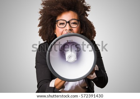 business black woman shouting on the megaphone Royalty-Free Stock Photo #572391430