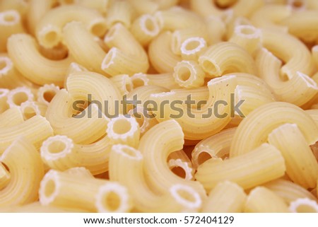 Macaroni raw dry pasta background concept. Pasta texture for background uses. Swirled pasta pattern. Food photography in studio.