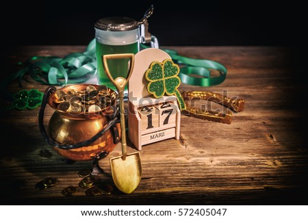 St Patrick's Day still life with pot of gold, shamrock and block calendar Royalty-Free Stock Photo #572405047