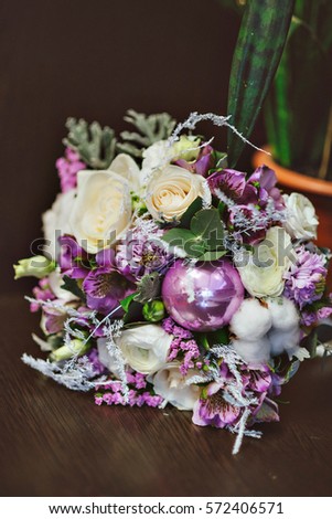 Wedding bouquet . Bridal bouquet in purple tones, with decorations and cotton. On a dark background.