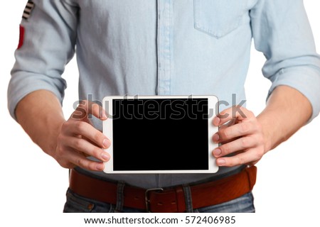 A man in a light blue shirt is holding tablet pc isolated on white, pointing to the screen tablet PC