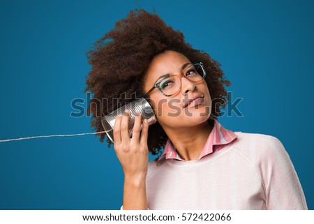 black woman holding a tin can Royalty-Free Stock Photo #572422066