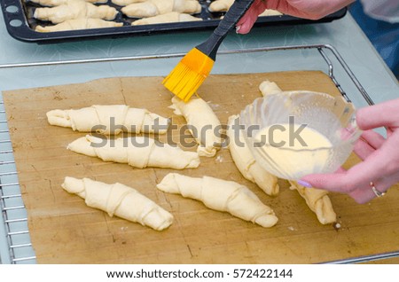 Girl makes homemade cinnamon buns, sliced rolls of dough roll. View from above, hands in picture