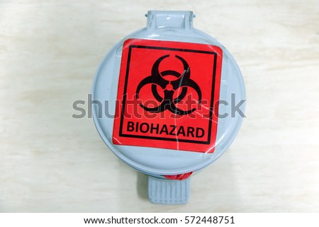 Waste bin with bio-hazard sign. The waste container of hazardous waste in the laboratory. Red - black bio hazard dangerous symbol on bin.