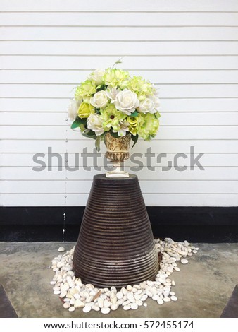 Bouquet of various flowers in vintage and modern vase over white wooden background.Exterior decor