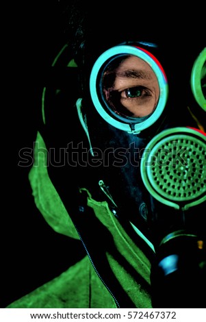 A man in a gas mask on a black background.