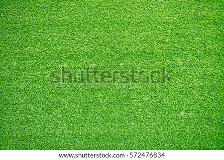 Natural grass texture patterned background in golf course turf from top view: Abstract background of authentic grassy lawn environmental textured pattern backdrop in bright yellow green color tone  Royalty-Free Stock Photo #572476834