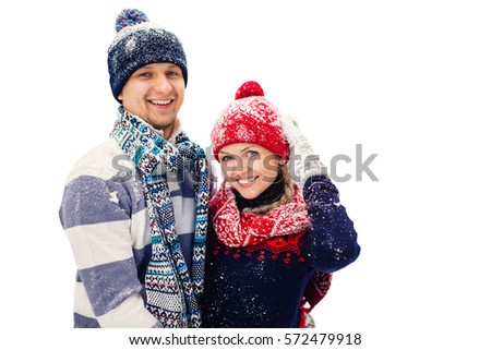 Attractive couple in winter clothes smiling at camera isolated with path