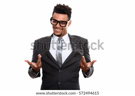 Young happy African businessman smiling while looking confused
