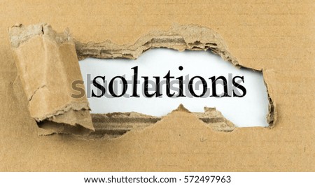 A torn carton, under which "solutions" appears