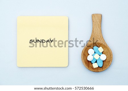 A medical pills in a wooden spoon with a medical note written on isolated white background. Medical, health care, education, and information concept