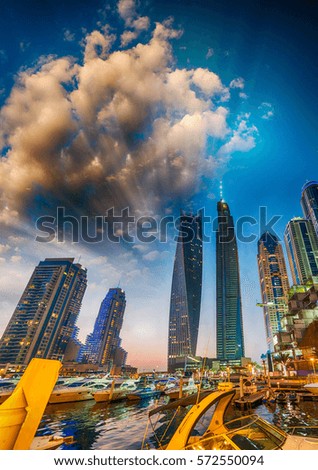 Sunset in Dubai Marina. Buildings reflections over artificial canal.
