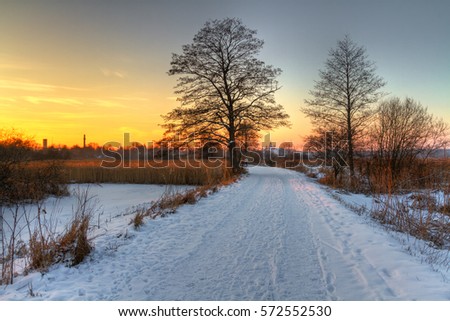 Landscape - sundown or sunset in Suprasl river valley. Winter time in Knyszynska Forest, North - Eastern part of Poland, Europe.