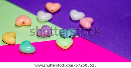 Color Hearts on color paper. Abstract background and gift card.