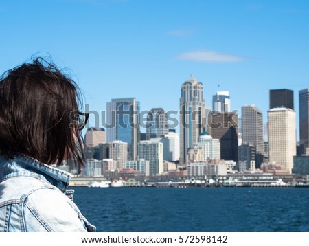 A tourist woman looking at seattle skyline west coast vacation