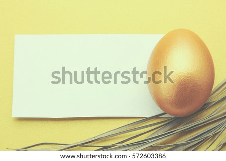 Golden egg on yellow background