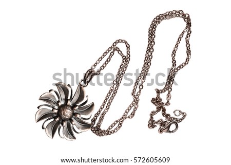 Bronze flower shaped pendant on a chain isolated over white