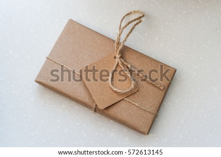 gift in a cardboard box with a label for the label