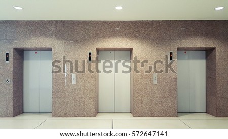 Open and closed chrome metal office building elevator doors realistic photo. Lift transportation floor to floors with push switch for up and down. Elevator disabled
