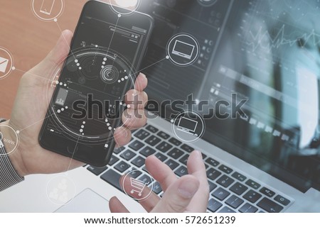 close up of hand using smart phone,laptop, online banking payment communication network technology 4.0,internet wireless application development sync app,virtual graphic icon diagram Royalty-Free Stock Photo #572651239