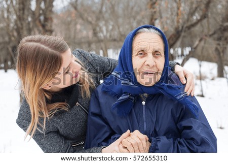 Picture of a happy elderly woman with her loving granddaughter