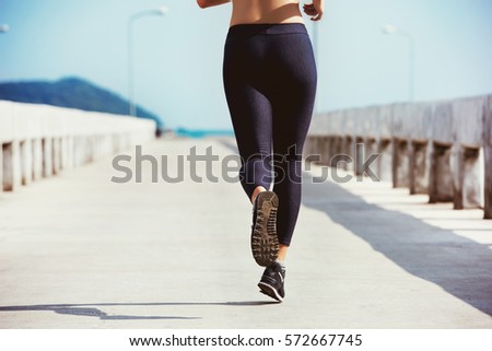 Closeup photo of running girl on sea pier. Space for text