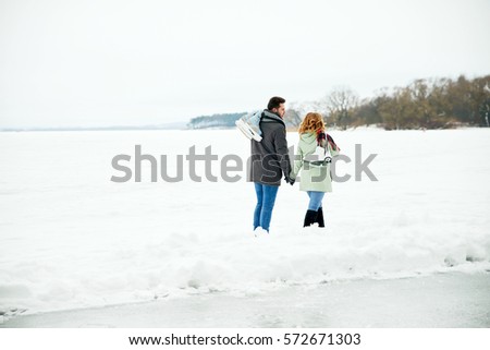 loving couple is skating on a frozen lake